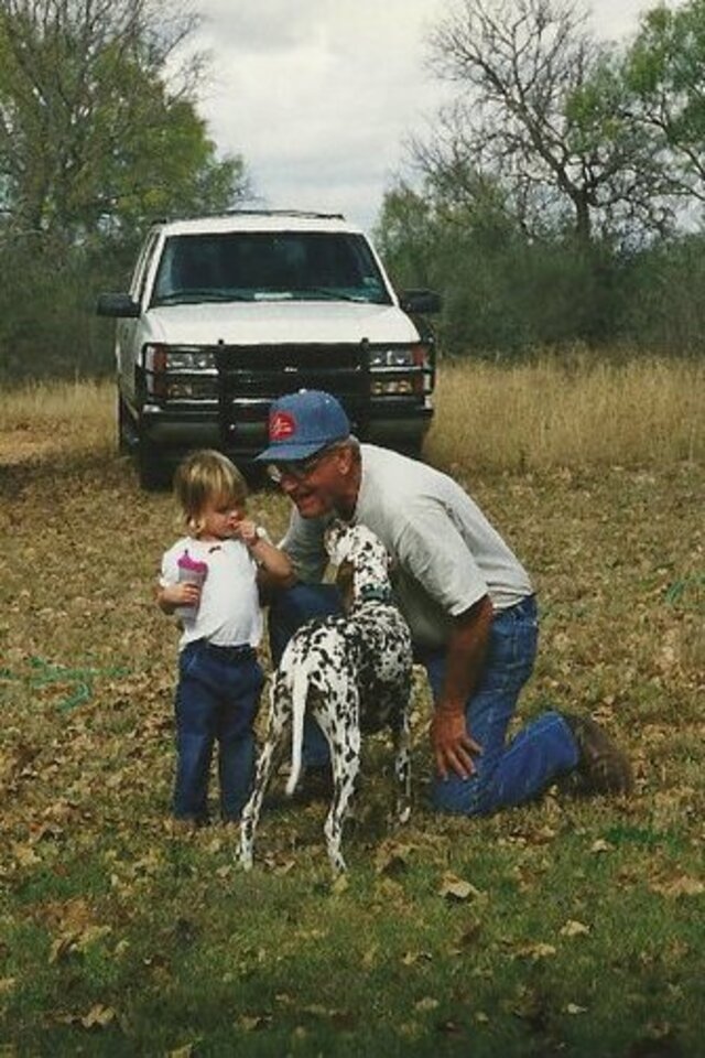 Young M.C. Huff with her grandfather at their Texas ranch with a Dalmatian dog